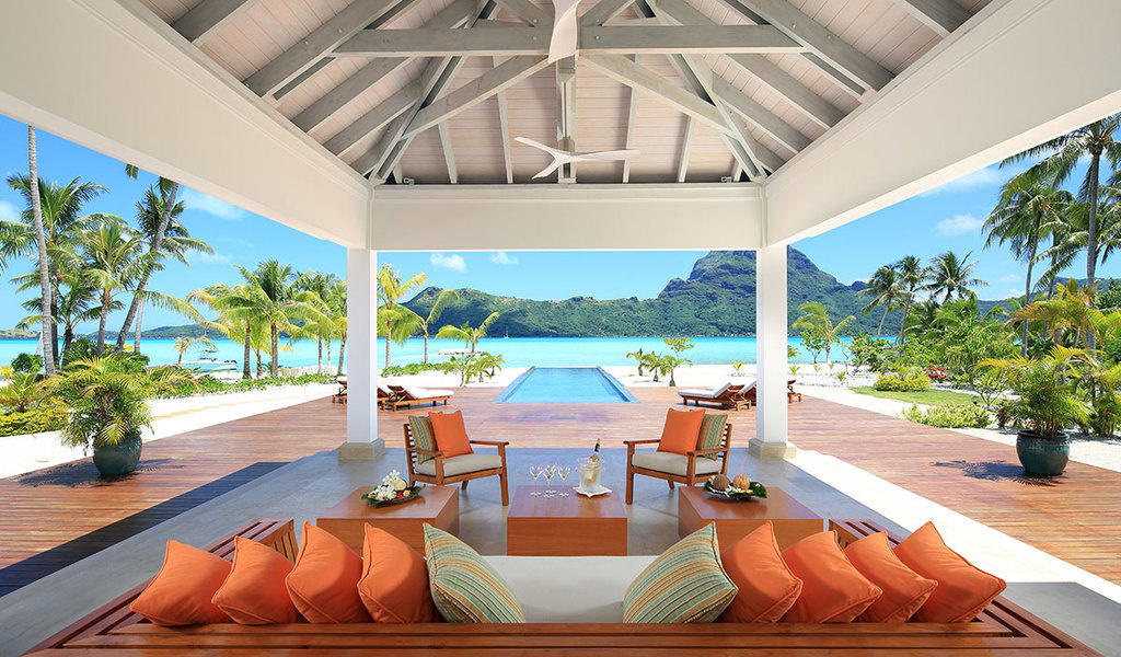 A Bora Bora One poolside lounge with view of lagoon and Bora Bora Island