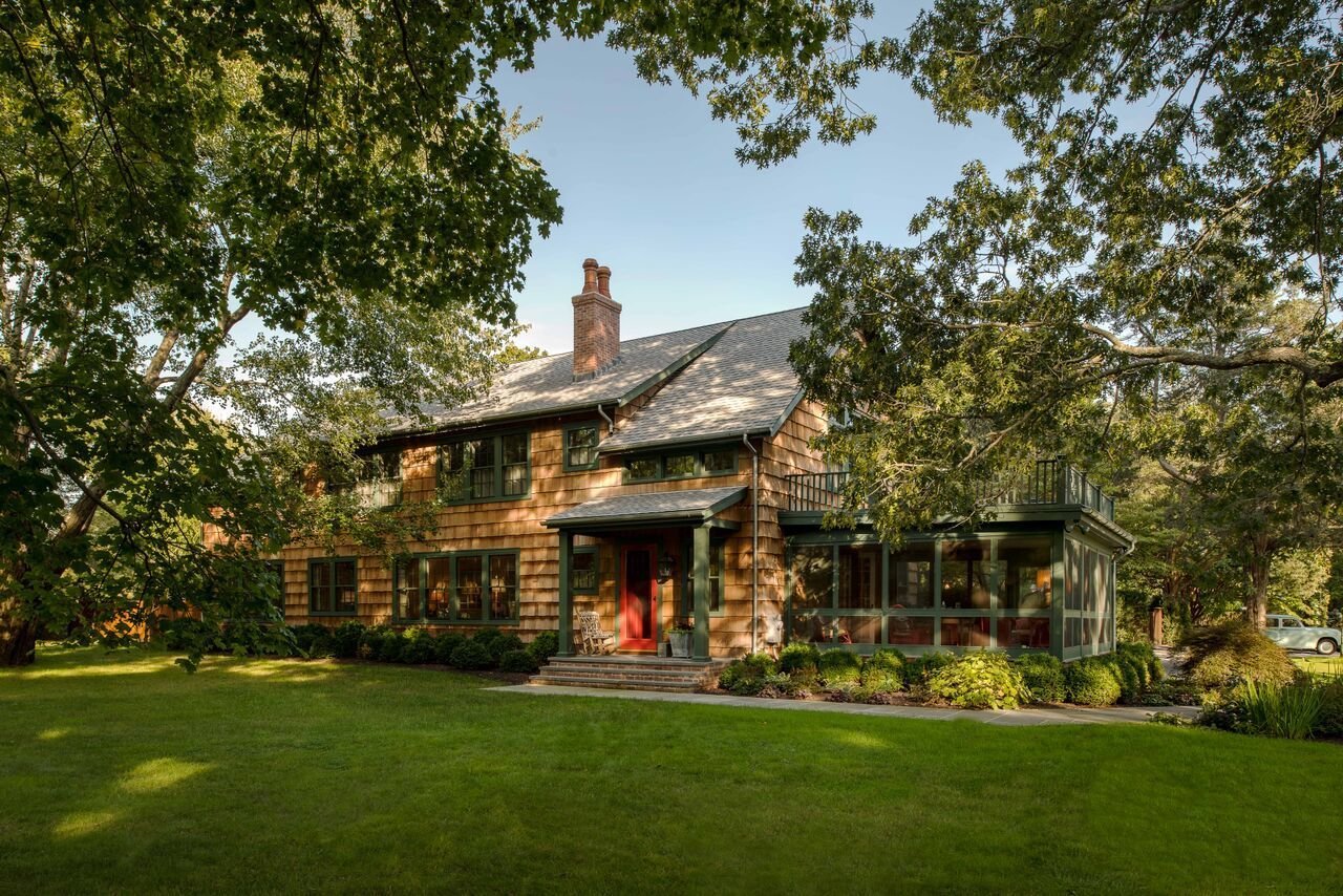 A rocking chair and potted plant create a warm welcome to this home designed by Phillip Thomas.