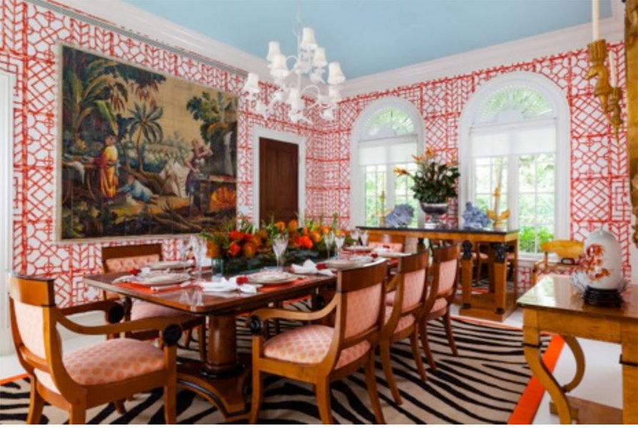 Red-patterned wallpaper in this dining room designed by Palm Beach, Florida-based designer Carleton V