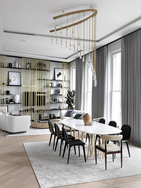 Shades of grey, black, and mixed metals create a layered look in this living room designed by Dara Hu