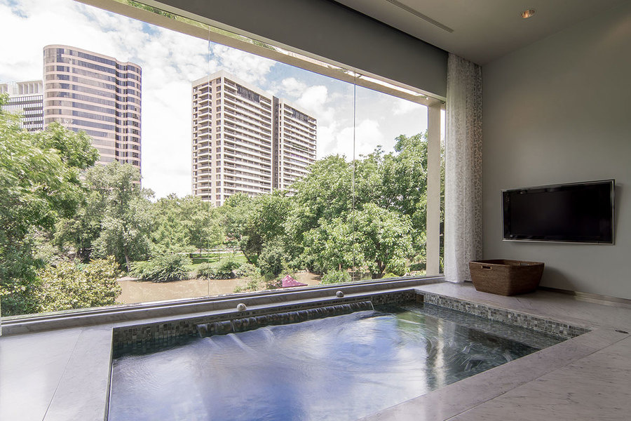 The master suite's jetted tub offers views of the city, or anything else via the adjoining flatscreen