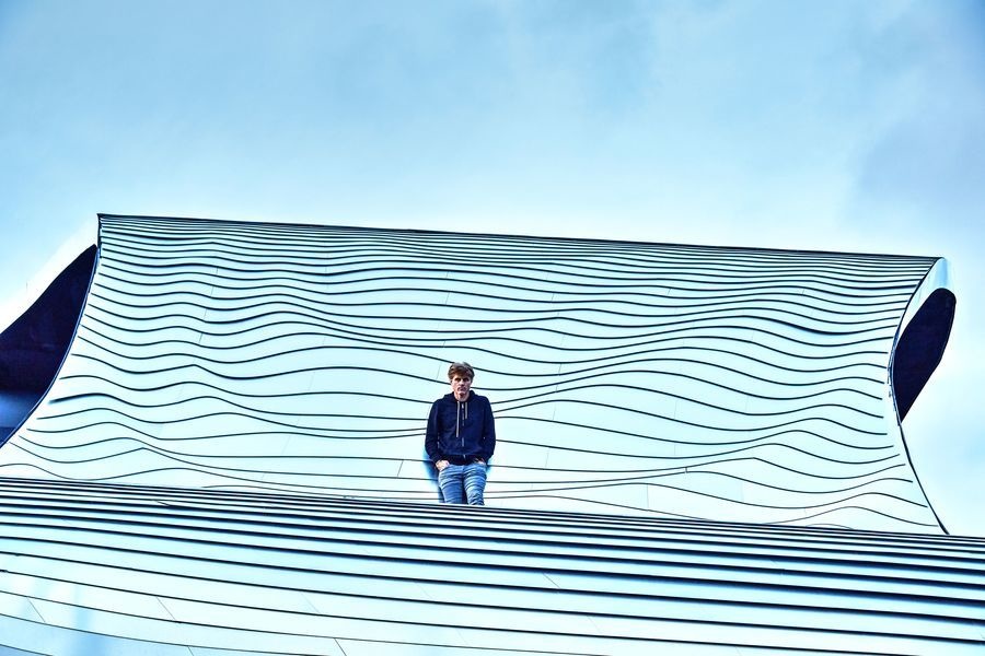 Mario Romano stands on the roof of Preston House.