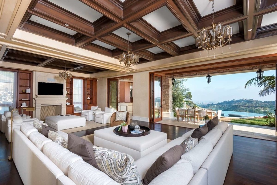 The home's living room extends outdoors and overlooks the Stone Canyon reservoir