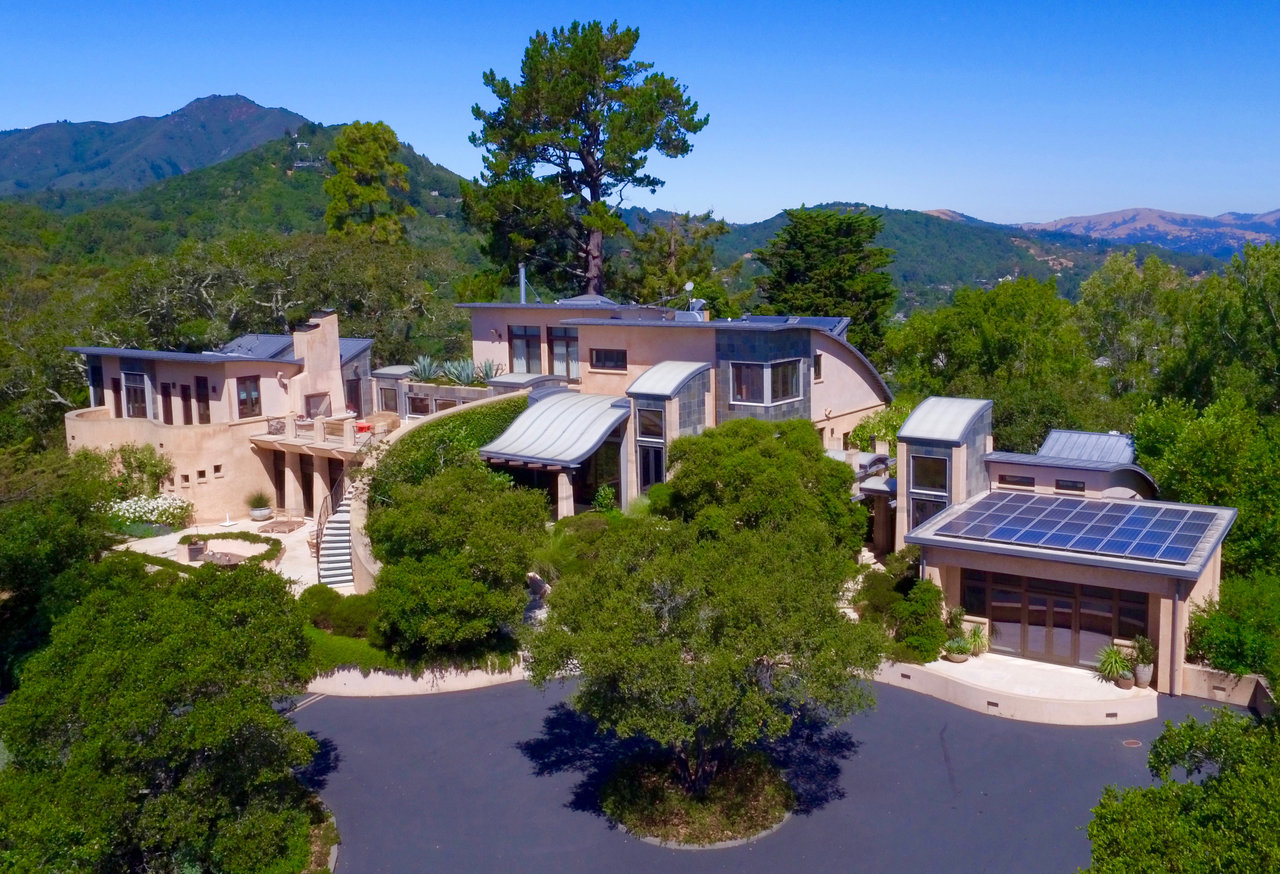 Topped with solar panels, the home features a rammed-earth exterior.