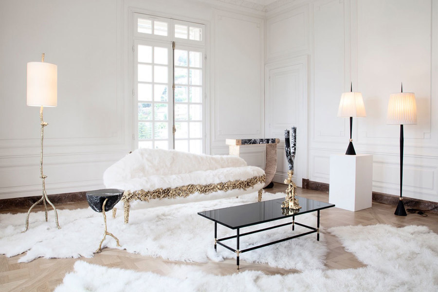 Neutral flooring and black furniture and accessories add depth to this luxurious living room installa