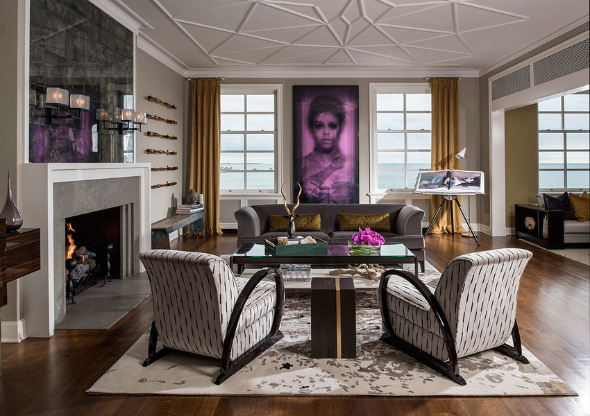 In this residential living room designed by Donna Mondi, decorative panels of curtains preserve the v