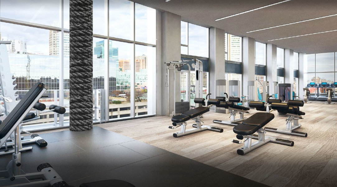 Soaring double-height windows lend light and an open feel to this airy gym designed by Kari Whitman.