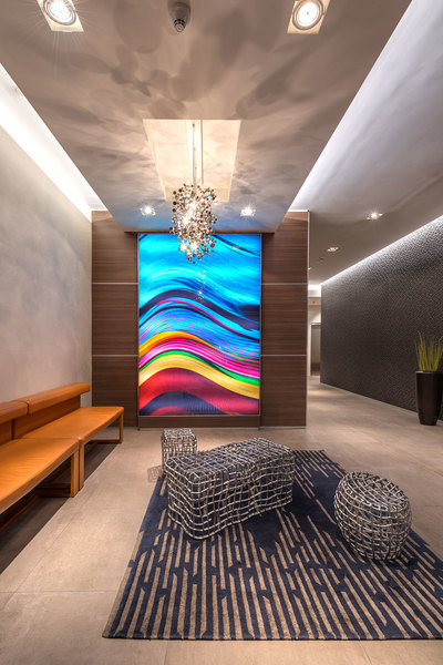 For a project at the Hyatt Centric, designer Kobi Karp mixed a bold, patterned piece of art with a tw