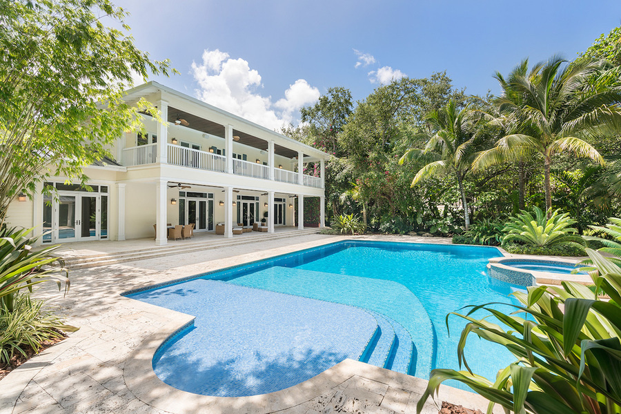 The pictured seven-bedroom Miami home is listed in U.S. dollars, as well as digital currency.